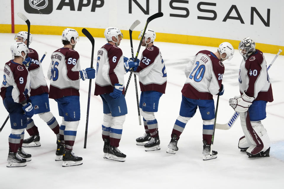 Colorado Avalanche players line up to congratulate goaltender Alexandar Georgiev (40) after a 4-3 win over the Nashville Predators in an NHL hockey game Friday, April 14, 2023, in Nashville, Tenn. (AP Photo/Mark Humphrey)