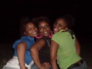 Candace Powell, left, Priscilla Williams, center, and Kierra Sykes, right, pose for a photo in 2009.