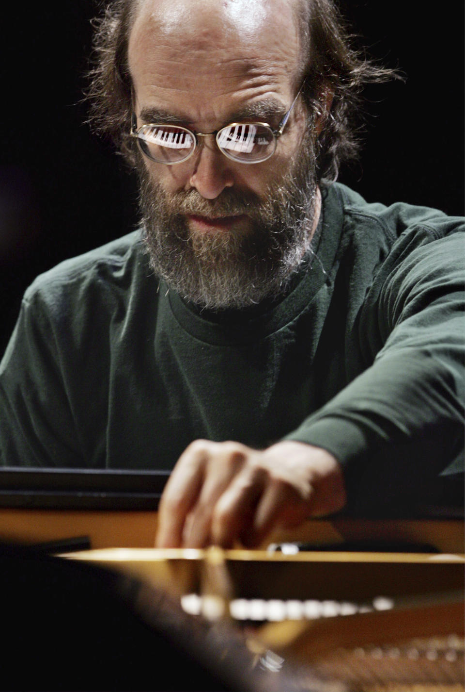 FILE - George Winston makes an adjustment on his piano during a sound check before his performance at the Cerritos Center for the Performing Arts in Cerritos, Calif., on Nov. 4, 2004. Winston, the Grammy-winning pianist who blended jazz, classical, folk and other stylings on such million-selling albums as “Autumn,” “Winter Into Spring” and “December,” died Sunday, June 4, 2023, after a 10-year battle with cancer. He was 73. (AP Photo/Reed Saxon, File)