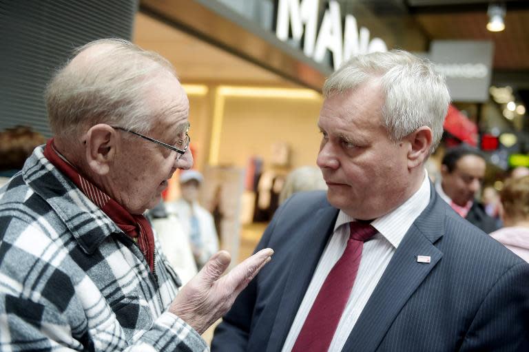 Chairman Antti Rinne (R) of the Social Democrats campaigns in Espoo, Finland on April 18, 2015 ahead of the parliamentary elections to take place on Sunday, April 19, 2015