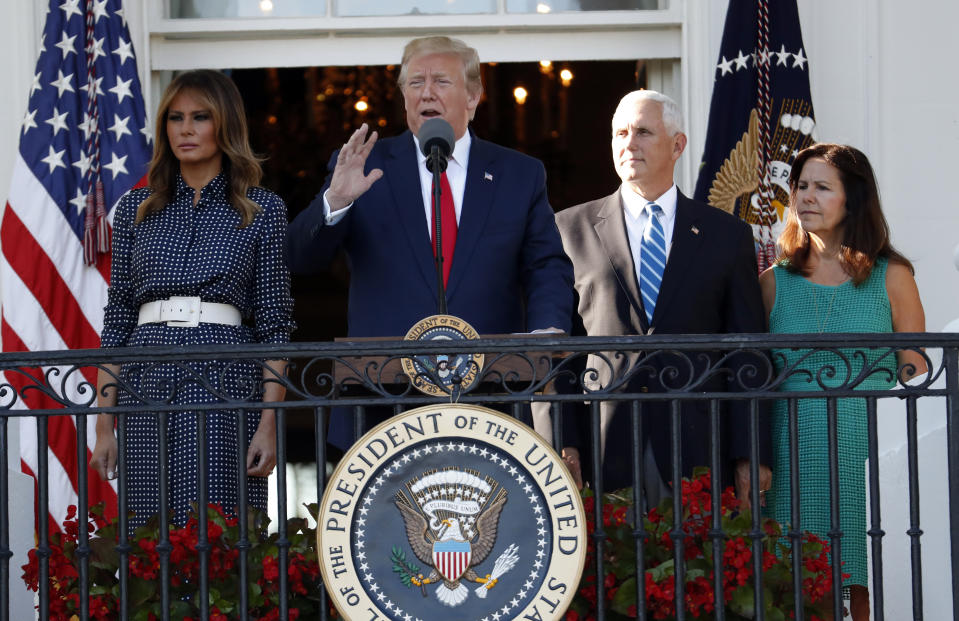 President Donald Trump, with first lady Melania Trump, and Vice President Mike Pence and his wife Karen, speaks from the Truman Balcony of the White House during the annual Congressional Picnic on the South Lawn, Friday June 21, 2019, in Washington. (AP Photo/Jacquelyn Martin)