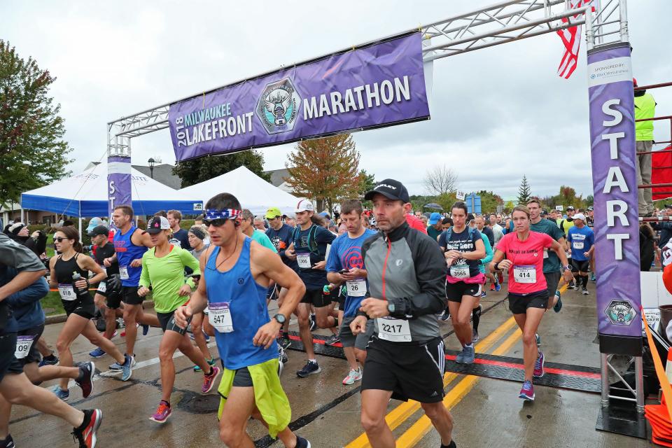 Runners leave the starting line of the Lakefront Marathon near Grafton High School on their way to a finish at Veterans Park on the Milwaukee lakefront.