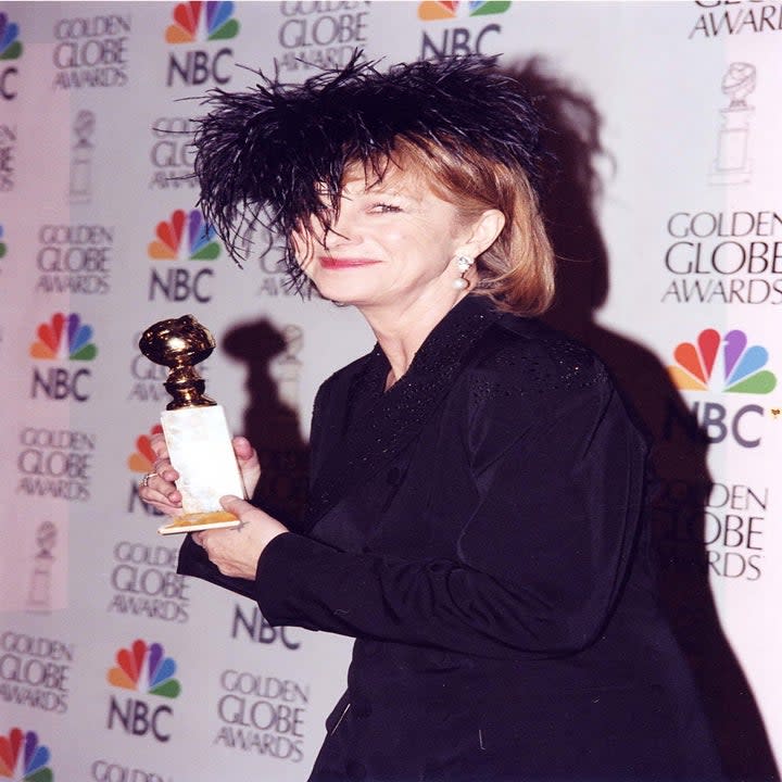 Helen Mirren holding her Golden Globe