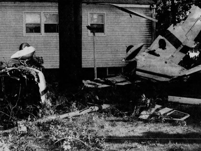 The wreckage of a small plane lies Sunday, May 30, 1999, against the Piscataway home of Rose Bergen. Seven people were injured in the second plane crash in Central Jersey in two days.