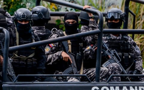 Members of the Bolivarian National Intelligence Service (SEBIN) patrol Caracas as an operation to capture Oscar Perez - Credit: JUAN BARRETO/AFP/Getty Images