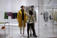 A staff member arranges the clothing on a mannequin in a boutique in a department store following an outbreak of the coronavirus disease (COVID-19) in Beijing