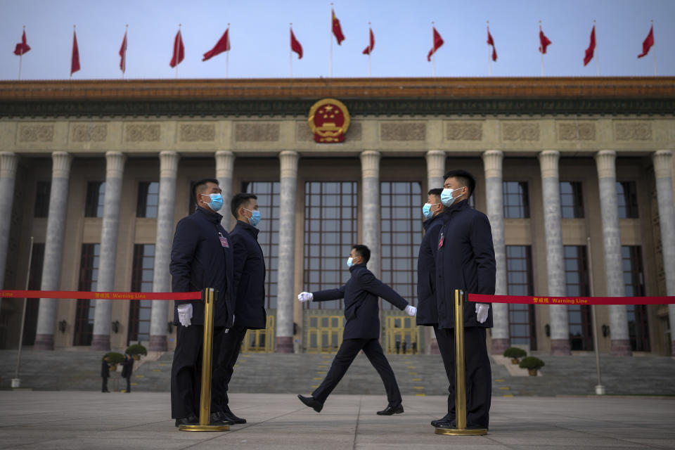 Soldiers dressed as ushers stand guard outside the Great Hall of the People ahead a preparatory session of the National People's Congress (NPC) in Beijing, Monday, March 4, 2024. (AP Photo/Andy Wong)