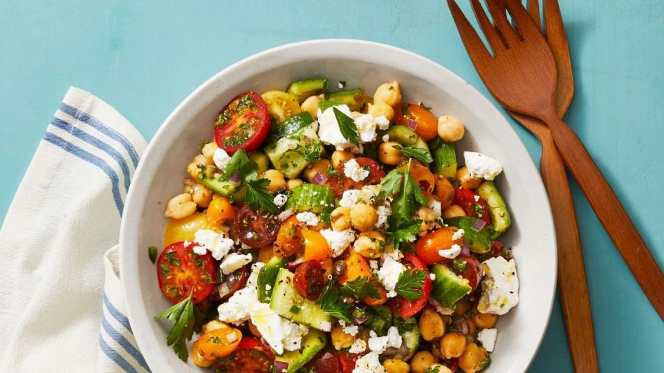 chickpea salad with smashed cucumbers in a white bowl