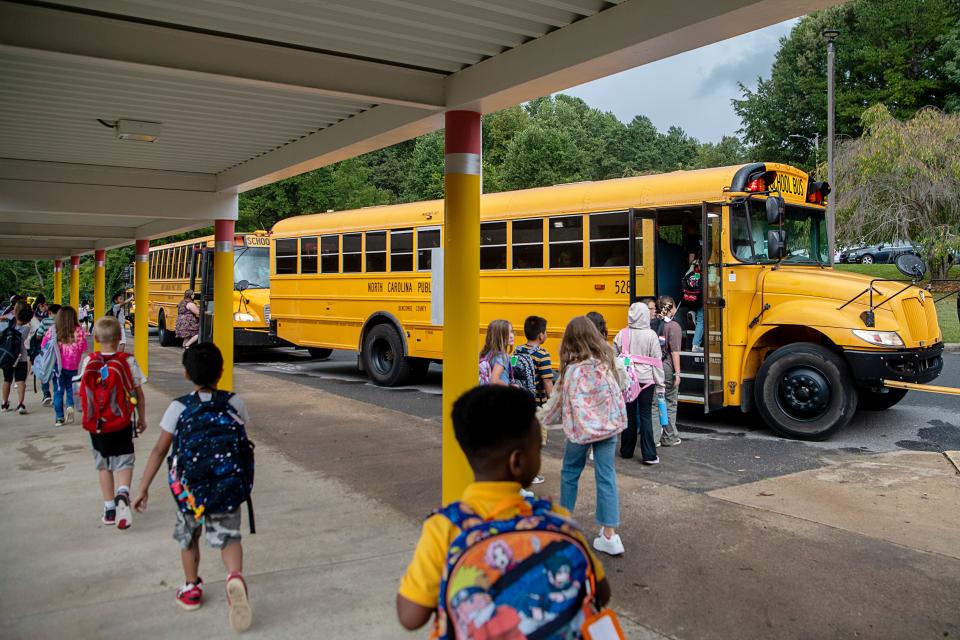 Students file onto buses after their first day of school at W.D. Williams Elementary in Swannanoa August 28, 2023.
