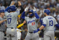 Los Angeles Dodgers' Teoscar Hernandez (37) celebrates with teammates Will Smith, left, Shohei Ohtani (17) and Max Muncy, right, after hitting a grand slam during the sixth inning of a baseball game against the San Diego Padres, Saturday, May 11, 2024, in San Diego. (AP Photo/Gregory Bull)