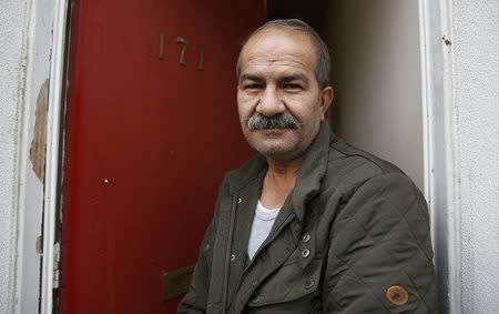 Iranian asylum seeker Mohammed Bagher Beyzevi poses for a photograph outside his home on Union Street in Middlesbrough, northern Britain, January 20, 2016. REUTERS/Phil Noble