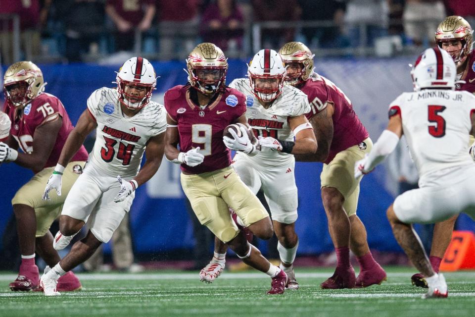 Florida State running back Lawrance Toafili (9) dodges Louisville defenders during the ACC championship title in Charlotte, North Carolina on Saturday, Dec. 2, 2023.