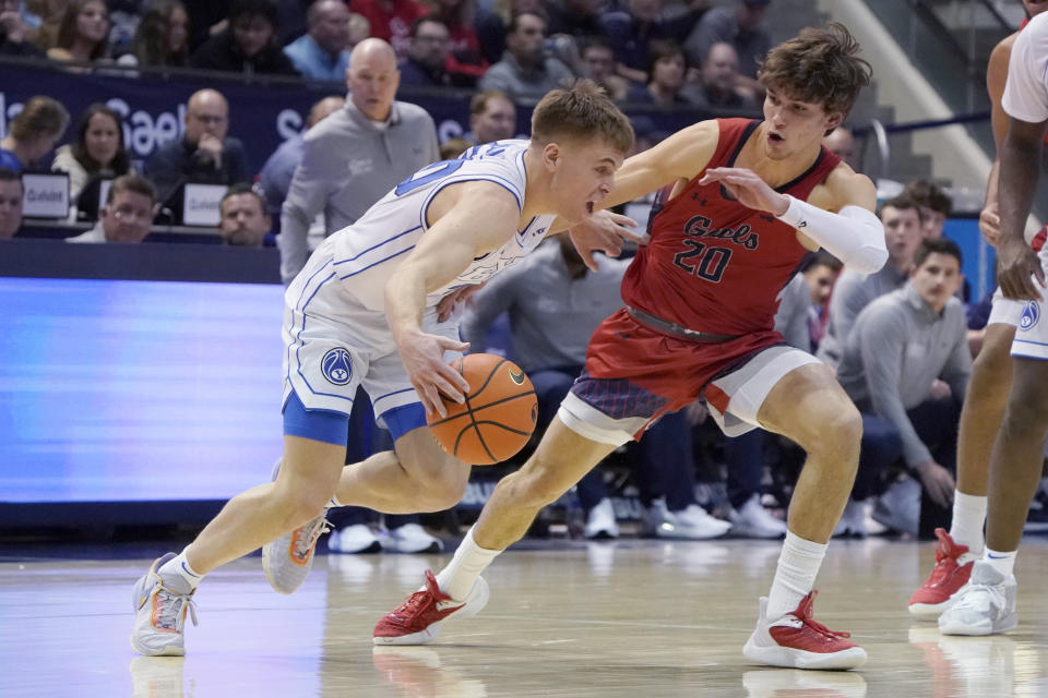 BYU guard Dallin Hall, left, drives against Saint Mary's guard Aidan Mahaney (20) during the first half of an NCAA college basketball game Saturday, Jan. 28, 2023, in Provo, Utah. (AP Photo/George Frey)