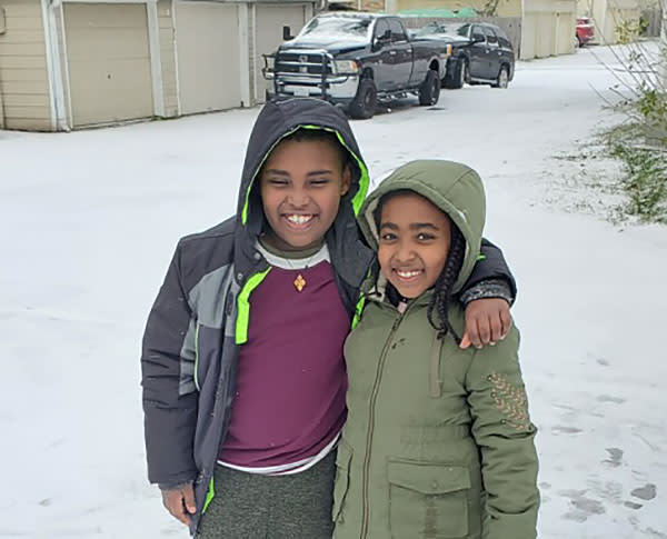 Shalemu Bekele's children, Beimnet, left, and Rakaeb enjoy the snow on the morning of Feb. 15. (Shalemu Bekele)