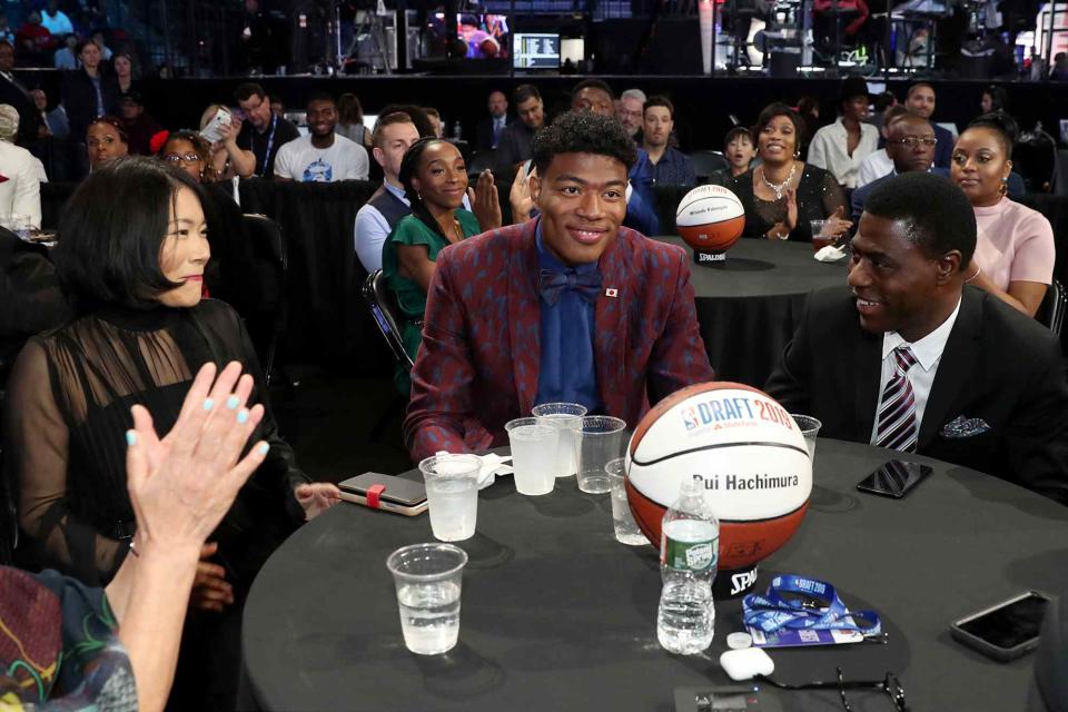 <p>Michael J. LeBrecht II/NBAE/Getty</p> Rui Hachimura and his parents Makiko Hachimura and Zakari Jabil during the 2019 NBA Draft on June 20, 2019.