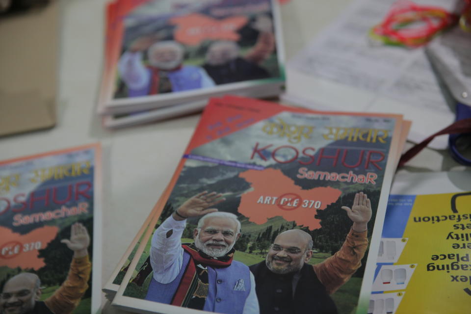 In this Aug. 19, 2019, photo, copies of a magazine called "Koshur,’" which features on the cover pictures of Indian Prime Minister Narendra Modi, left, and Home Minister Amit Shah, and shows a sign that symbolizes the abrogation of Article 370 that gave disputed Kashmir special privileges lie at Kashmiri Samiti, an organization of Kashmiri Hindus in New Delhi, India. Though people in Muslim-majority Kashmir have been protesting the Indian government’s move, Kashmiri Hindus, who had to flee from their homes nearly three decades ago, view it as a step towards justice. (AP Photo/Rishabh R. Jain.)