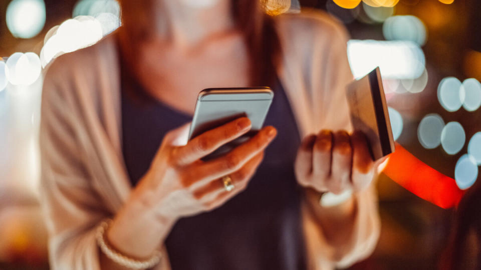 woman looking at her credit card