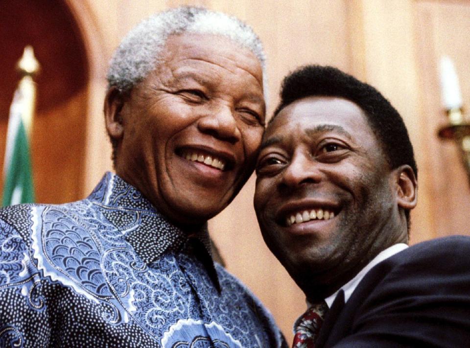 President Nelson Mandela and Pele smile for photographers at Union Buildings in Pretoria, South Africa, March 24, 1995. (Reuters)