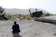 A man inspects damage of an airstrike on a truck in the northwestern city of Saada, Yemen June 21, 2018. REUTERS/Naif Rahma