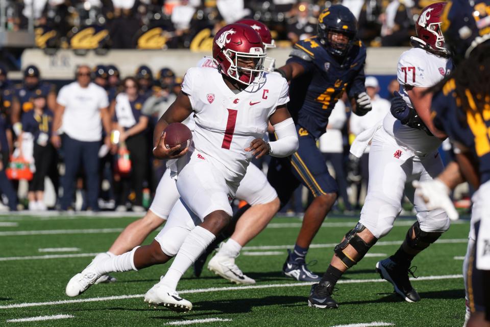 Washington State quarterback Cameron Ward (1) rushes for a touchdown against California during the first quarter at California Memorial Stadium.