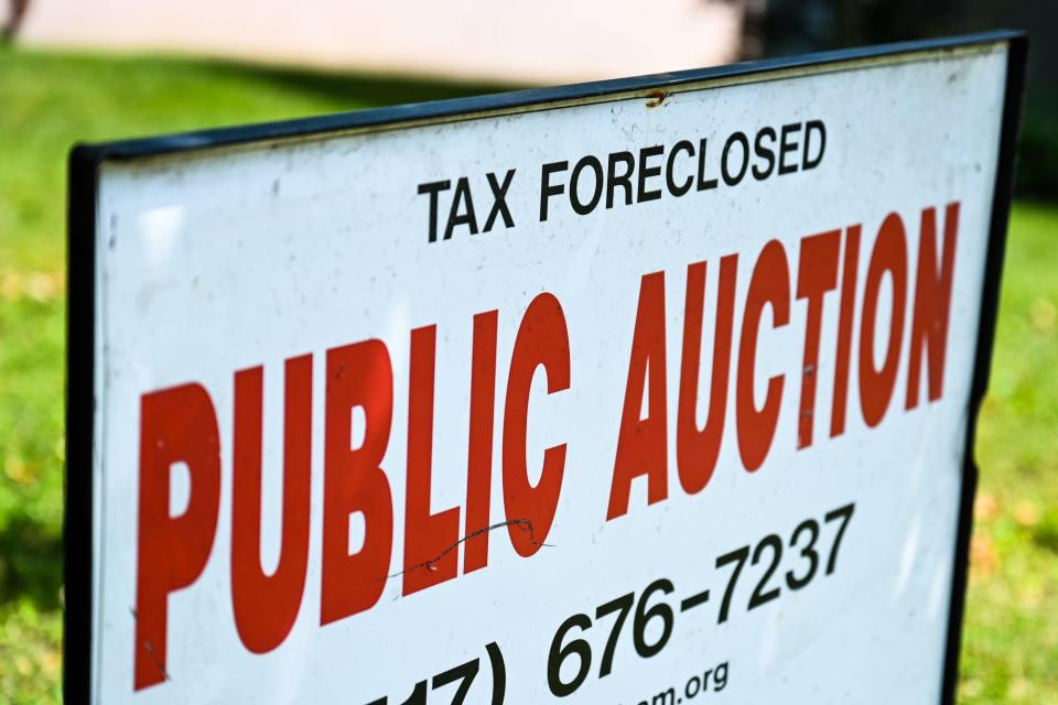 A sign outside a property on Pamela Place that is up for tax foreclosure auction photographed on Tuesday, July 26, 2022, in Lansing.