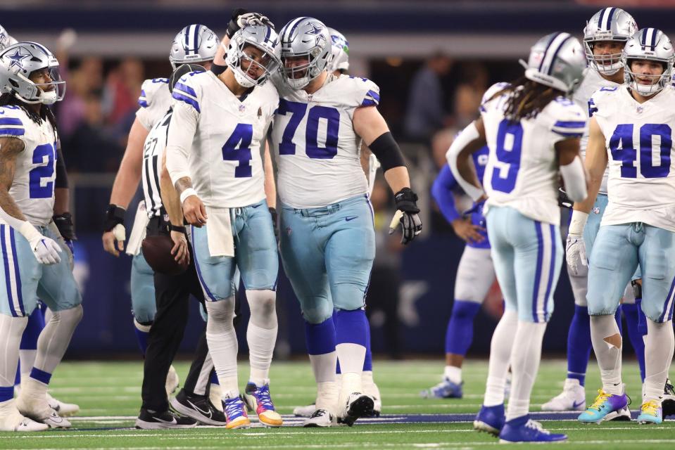 Nov 30, 2023; Arlington, Texas, USA; Dallas Cowboys quarterback Dak Prescott (4) and guard Zack Martin (70) celebrate during the second half against the Seattle Seahawks at AT&T Stadium. Mandatory Credit: Tim Heitman-USA TODAY Sports