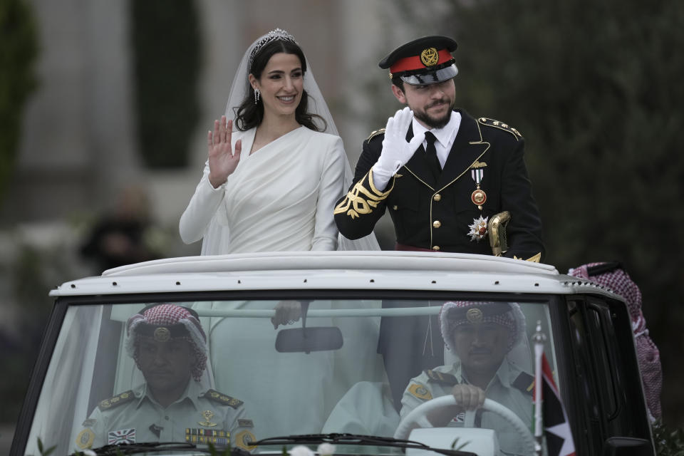 Jordan's Crown Prince Hussein and Saudi Rajwa Alseif wave to well-wishers during their wedding ceremonies in Amman, Jordan, Thursday, June 1, 2023. (AP Photo/Nasser Nasser)