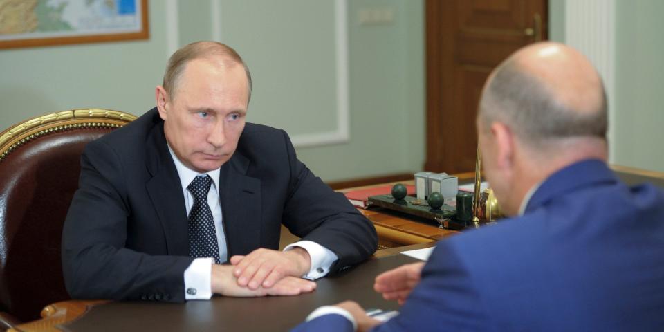 Russian President Putin speaks with Finance Minister Siluanov during their meeting at the Novo-Ogaryovo state residence