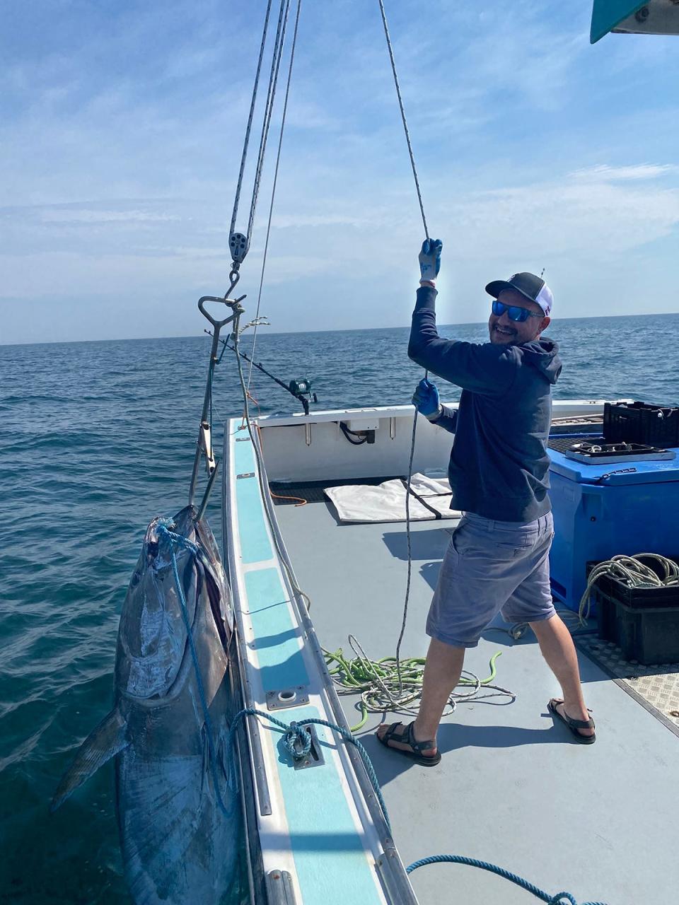 Brian Carney helps Keper Connell haul a bluefin tuna from the waters of Jeffreys Ledge into the fishing boat Figment.