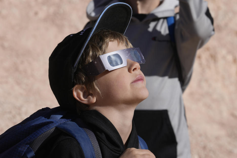 People watch the moon passes between earth and the sun during a rare "ring of fire" eclipse of the sun Saturday, Oct. 14, 2023, in Bryce Canyon National Park, Utah. (AP Photo/Rick Bowmer)