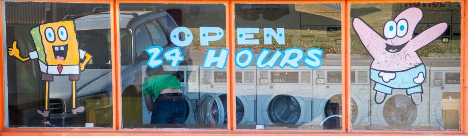 A customer uses the Crystal Clean Laundromat in Gosport on Wednesday, Nov. 15, 2023.