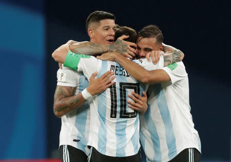 Soccer Football - World Cup - Group D - Nigeria vs Argentina - Saint Petersburg Stadium, Saint Petersburg, Russia - June 26, 2018 Argentina's Marcos Rojo, Lionel Messi and Gabriel Mercado celebrate after the match REUTERS/Henry Romero