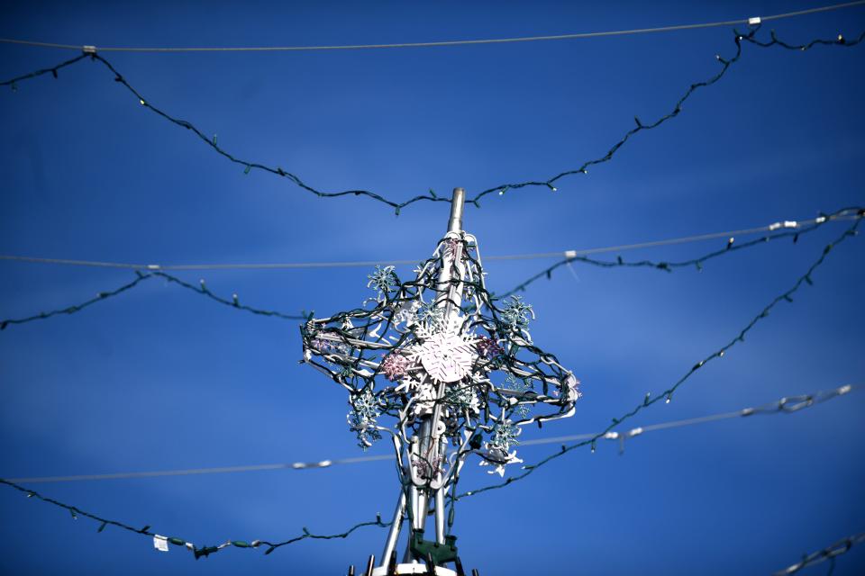 A star sits on top of and umbrella Christmas tree at Umbrella Alley in Louisville.  Wednesday, December 21, 2022.