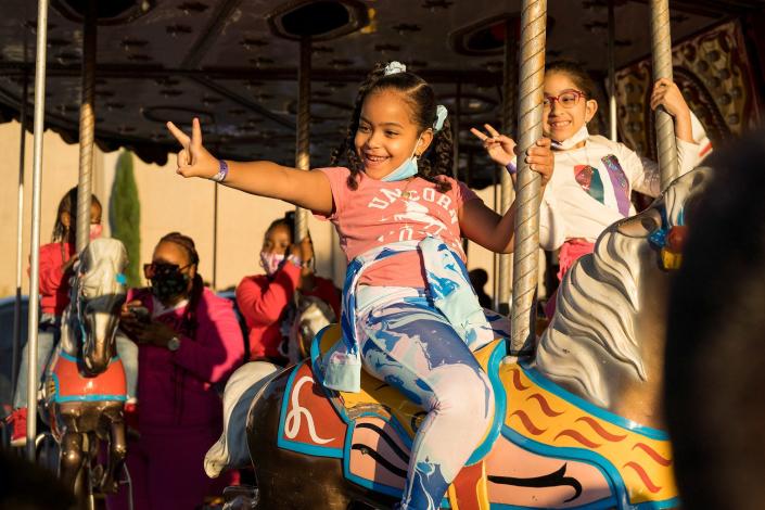 NC State Fair admission and ride tickets are available for advance purchase at a discounted rate through Oct. 13. In this 2021 photo, two young girls enjoy a ride on the merry-go-round.