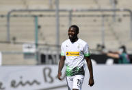 Moenchengladbach's Marcus Thuram smiles after scoring his side's third goal during the German Bundesliga soccer match between Borussia Moenchengladbach and Union Berlin in Moenchengladbach, Germany, Sunday, May 31, 2020. The German Bundesliga becomes the world's first major soccer league to resume after a two-month suspension because of the coronavirus pandemic. (AP Photo/Martin Meissner, Pool)