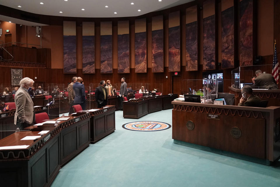 FILE - In this Feb. 18, 2021 file photo State representatives gather at the Capitol, in Phoenix. Two years after Arizona lawmakers repealed a law barring any instruction on HIV or AIDS that that "promotes a homosexual lifestyle," they are close to enacting a broad remake of the state's sex education laws with a particular focus on LGBTQ issues. (AP Photo/Matt York,File)