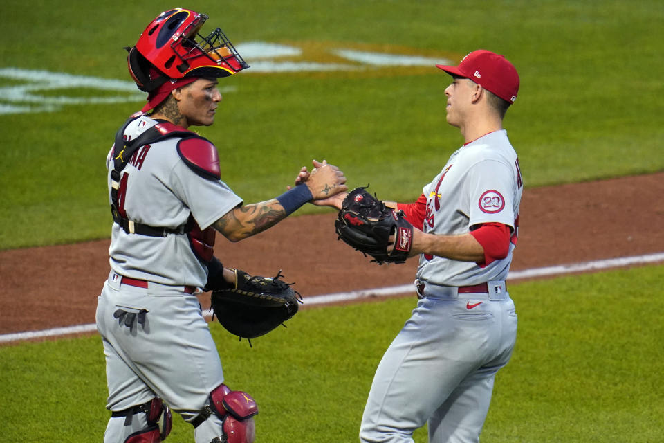 St. Louis Cardinals relief pitcher Ryan Helsley, right, celebrates with catcher Yadier Molina after the first baseball game of the team's doubleheader against the Pittsburgh Pirates in Pittsburgh, Friday, Sept. 18, 2020. The Cardinals won 6-5. (AP Photo/Gene J. Puskar)