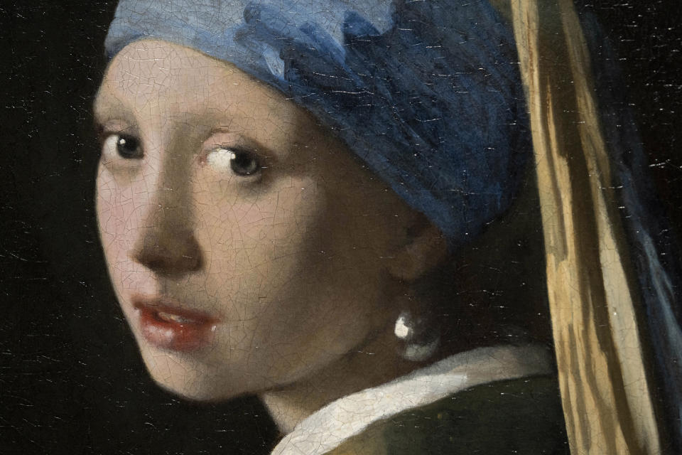 Detail of Girl with a Pearl Earring during a press preview of the Vermeer exhibit at Amsterdam's Rijksmuseum, Monday, Feb. 6, 2023, which unveils its blockbuster exhibition of 28 paintings by 17th-century Dutch master Johannes Vermeer drawn from galleries around the world. (AP Photo/Peter Dejong)