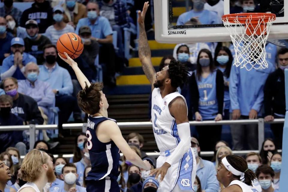 North Carolina guard Leaky Black (1) goes up in an attempt to block a shot by Virginia guard Kody Stattmann (23) during the first half of an NCAA college basketball game Saturday, Jan. 8, 2022, in Chapel Hill, N.C. (Photo/Chris Seward)