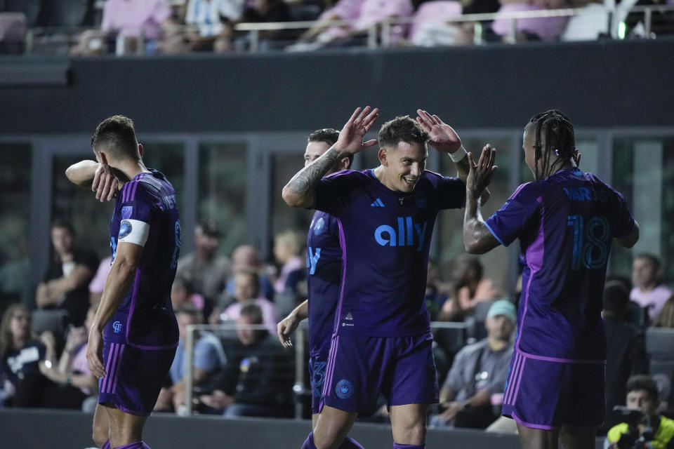 Charlotte FC forward Enzo Copetti, second right, celebrates with Charlotte FC forward Kerwin Vargas (18) after scoring his side's first goal against Inter Miami during the first half of an MLS soccer match, Wednesday, Oct. 18, 2023, in Fort Lauderdale, Fla. (AP Photo/Rebecca Blackwell)