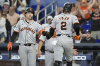 San Francisco Giants' Patrick Bailey congratulates Jorge Soler (2) after Soler scored during the second inning of a baseball game against the Miami Marlins, Wednesday, April 17, 2024, in Miami. (AP Photo/Marta Lavandier)