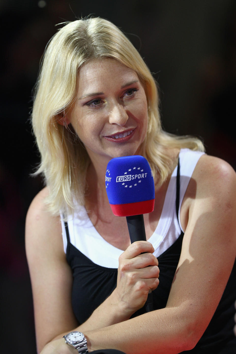 Barbara Schett smiling and answering questions during a live panel.