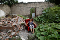 <p>Teresa Luna, 49, a seamstress, poses for a portrait with her dog Dokie, next to part of her house which was badly damaged after an earthquake in Chietla, Mexico, September 28, 2017. With the help of her family Luna was able to rescue some furniture. “The most valuable thing that I recovered was my dog,” Luna said. She is living in her backyard and hopes to return when the damage is repaired. (Photo: Edgard Garrido/Reuters) </p>