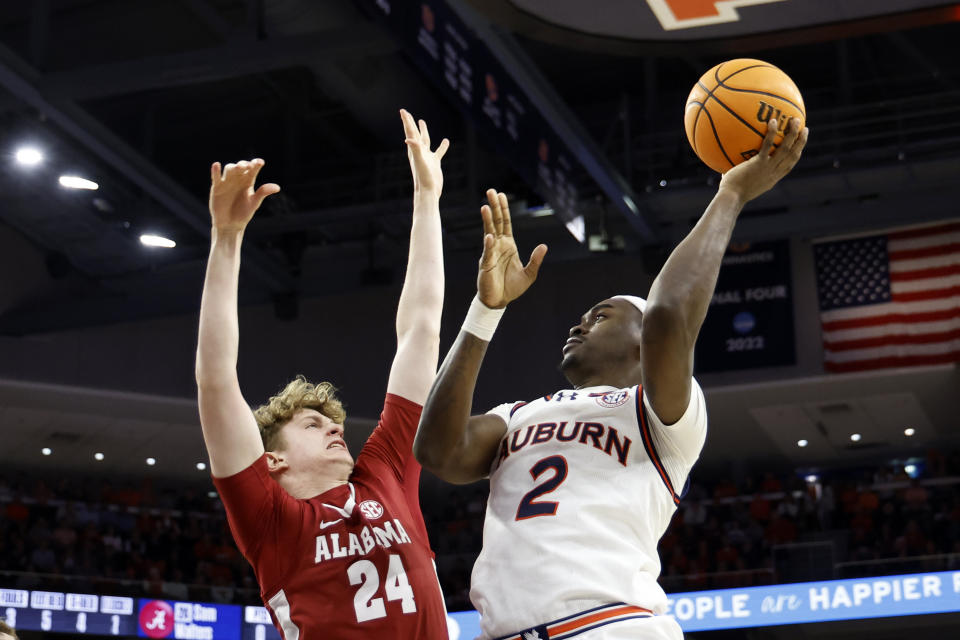 Auburn forward Jaylin Williams (2) shoots over Alabama forward Sam Walters (24) during the second half of an NCAA college basketball game, Wednesday, Feb. 7, 2024, in Auburn, Ala. (AP Photo/Butch Dill)