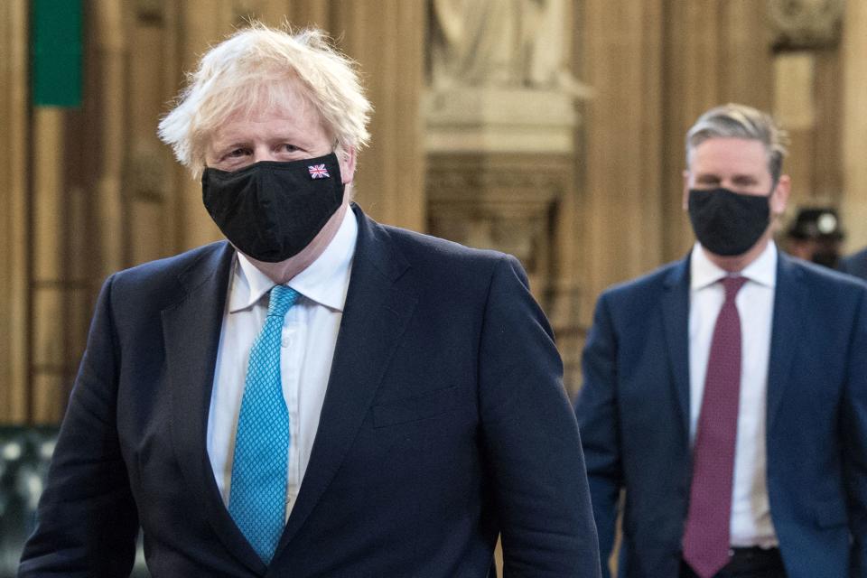 Britain&#39;s Prime Minister Boris Johnson (L) and Britain&#39;s main opposition Labour Party leader Keir Starmer, both wearing face coverings, lead MPs in a socially distanced single file line through the Central Lobby during the State Opening of Parliament at the Houses of Parliament in London on May 11, 2021, which is taking place with a reduced capacity due to Covid-19 restrictions. - The State Opening of Parliament is where Queen Elizabeth II performs her ceremonial duty of informing parliament about the government&#39;s agenda for the coming year in a Queen&#39;s Speech. (Photo by Stefan Rousseau / POOL / AFP) (Photo by STEFAN ROUSSEAU/POOL/AFP via Getty Images)