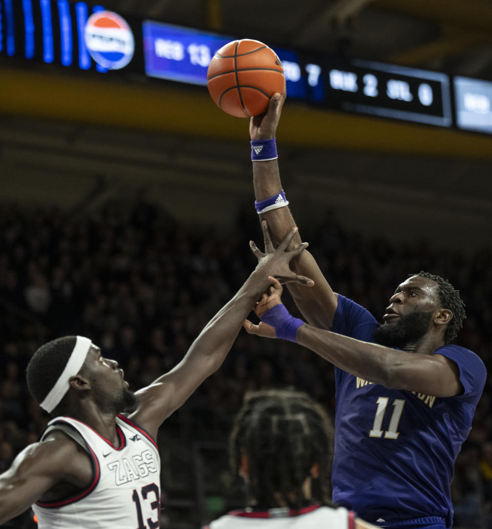 Washington's Franck Kepnang, right, goes up for a shot against Gonzaga's Graham Ike during the first half of an NCAA college basketball game Saturday, Dec. 9, 2023, in Seattle. (AP Photo/Stephen Brashear)