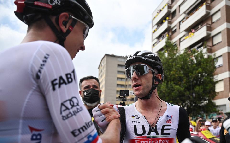 UAE Team Emirates' Adam Yates celebrates after winning stage 1 with team-mate Tadej Pogacar