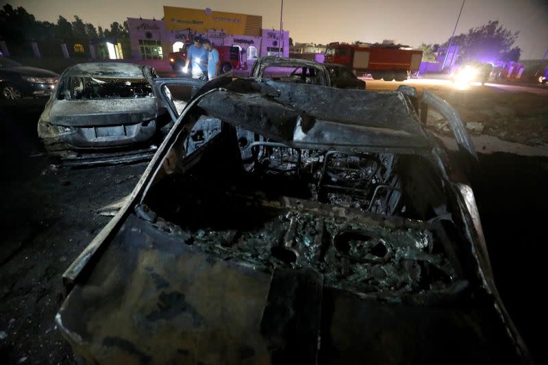 Burned vehicles are seen following a fire that broke out in Egypt's Shuqair-Mostorod crude oil pipeline, at the beginning of Cairo-Ismailia road