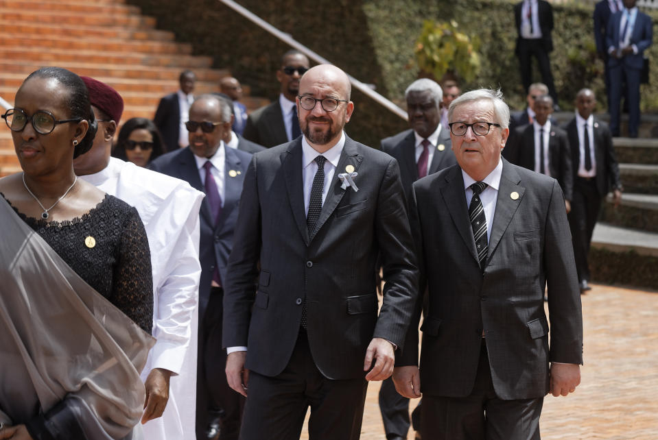 Prime Minister of Belgium Charles Michel, center, President of the European Commission Jean-Claude Juncker, right, and Rwanda's First Lady Jeannette Kagame, left, arrive to lay wreaths at the Kigali Genocide Memorial in Kigali, Rwanda Sunday, April 7, 2019. Rwanda is commemorating the 25th anniversary of when the country descended into an orgy of violence in which some 800,000 Tutsis and moderate Hutus were massacred by the majority Hutu population over a 100-day period in what was the worst genocide in recent history. (AP Photo/Ben Curtis)