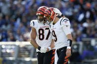 Cincinnati Bengals tight end C.J. Uzomah (87) and quarterback Joe Burrow (9) react after they connected for a touchdown pass during the second half of an NFL football game, Sunday, Oct. 24, 2021, in Baltimore. (AP Photo/Gail Burton)
